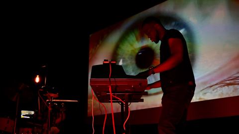 Keyboardist performing in front of Visibox visuals